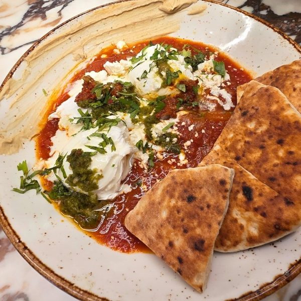 Shakshuka with poached eggs and warm pita at Crave Café