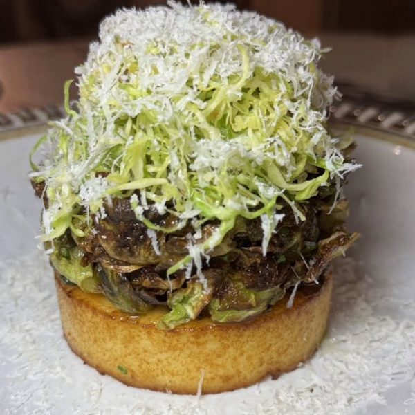 Open-faced burger with shaved lettuce at Crave Café